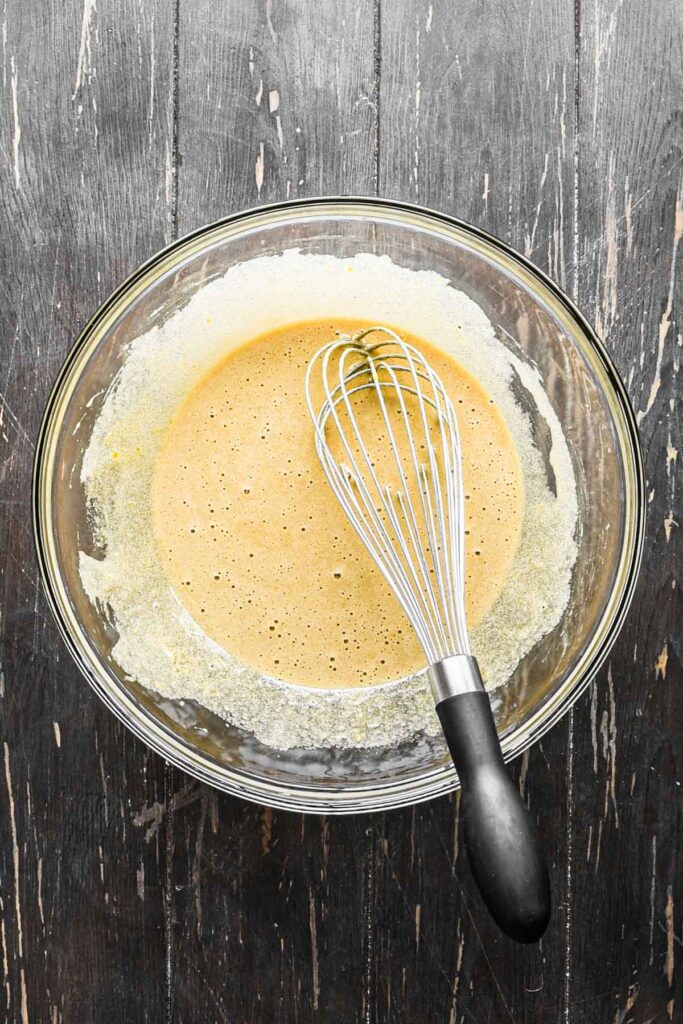 Mixing eggs and sugar for apple spice cake.