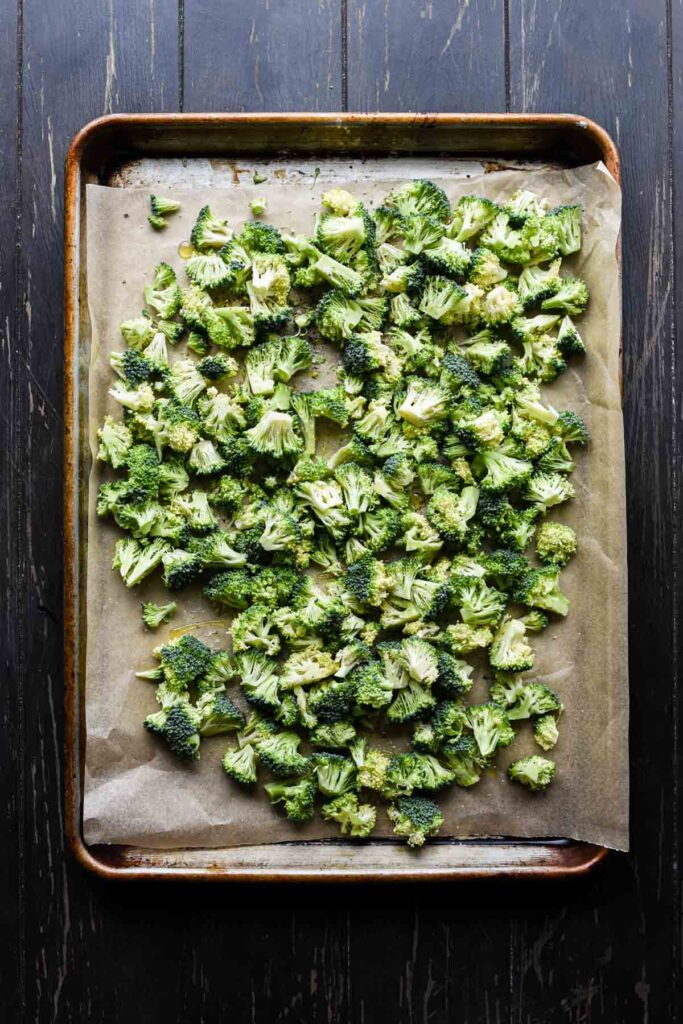 Roasting the broccoli on a sheet tray.