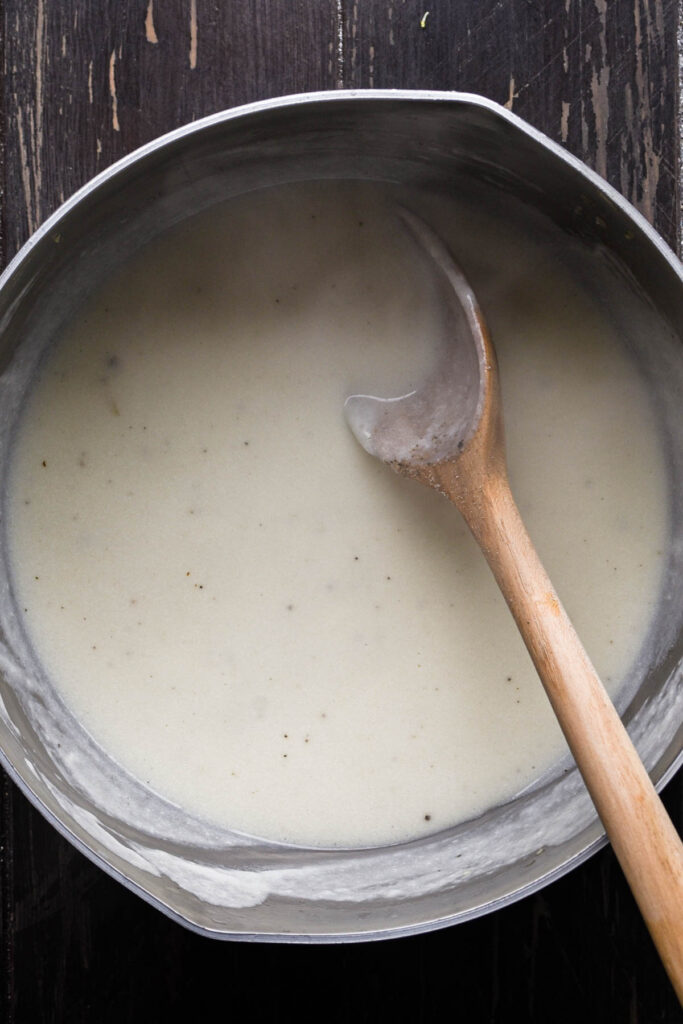 Cheeses, salt, and pepper added to roux.