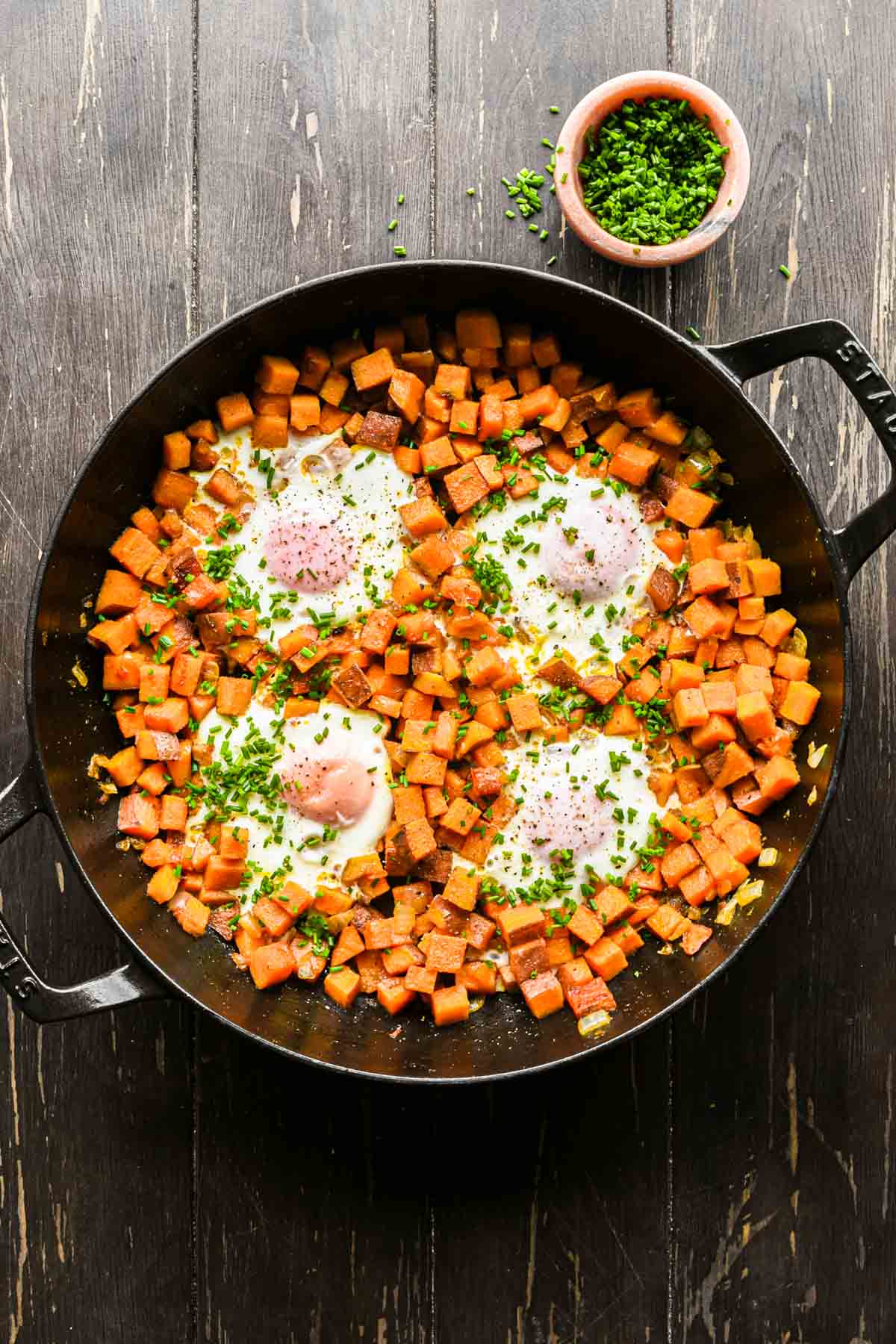 Sweet potato egg hash topped with chives.