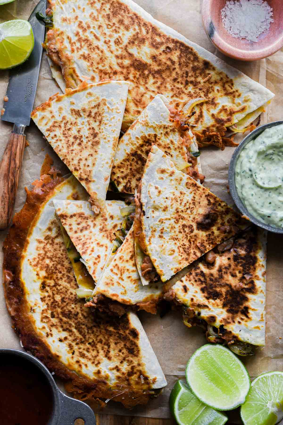 Finished refried bean quesadillas on a platter.