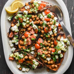 Finished mediterranean sweet potatoes on a serving tray.