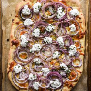 Finished onion pizza with ricotta and oregnano.