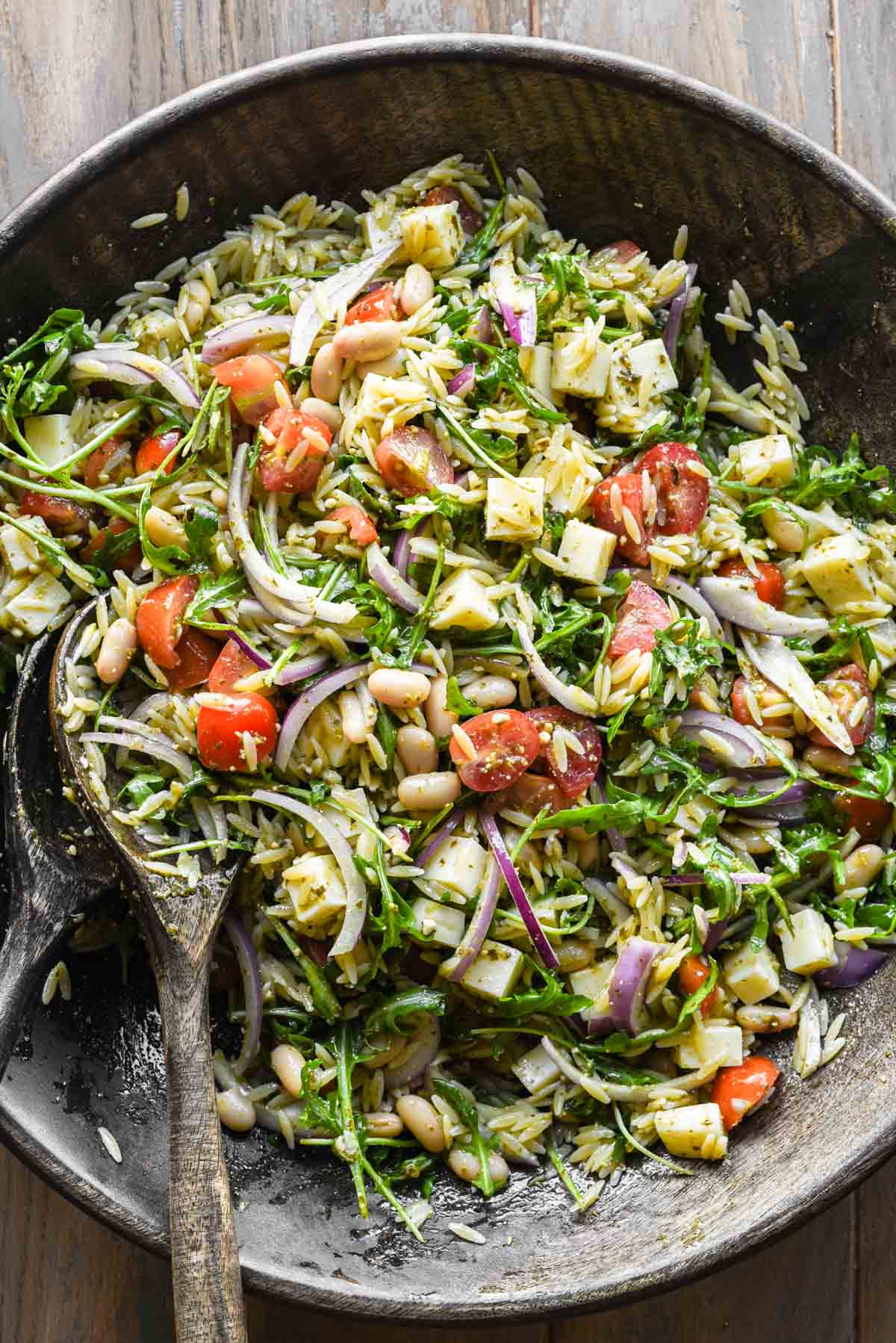 Ingredients for the pesto orzo pasta salad all mixed together.