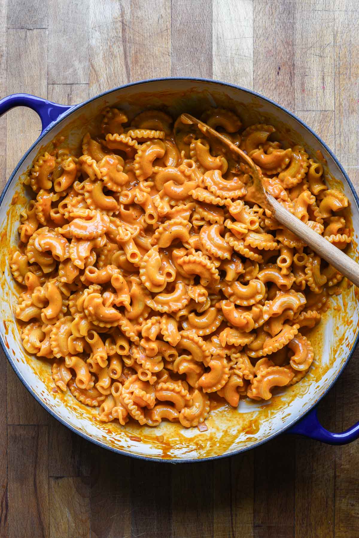 Gochujang pasta in a pot with wood spoon.