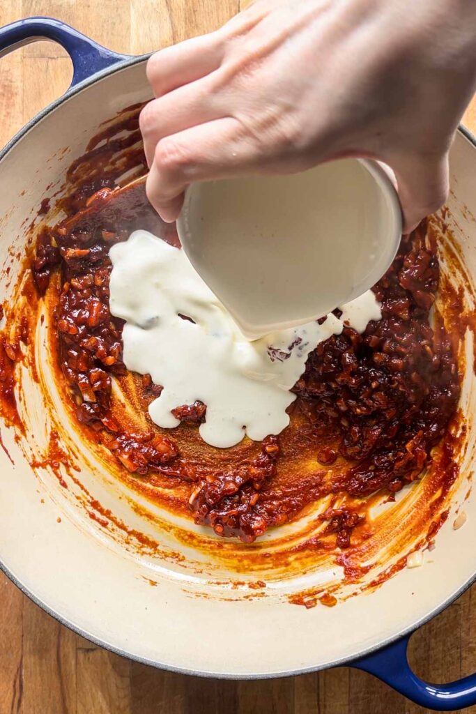 Pouring in cream.