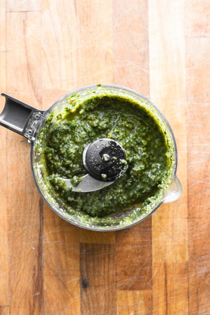 Parmesan cheese added to food processor.