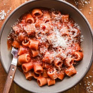 Spicy tomato sauce in a bowl with parmesan cheese on top.