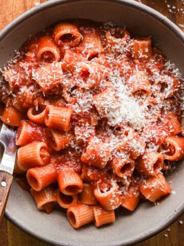 Spicy tomato sauce in a bowl with parmesan cheese on top.