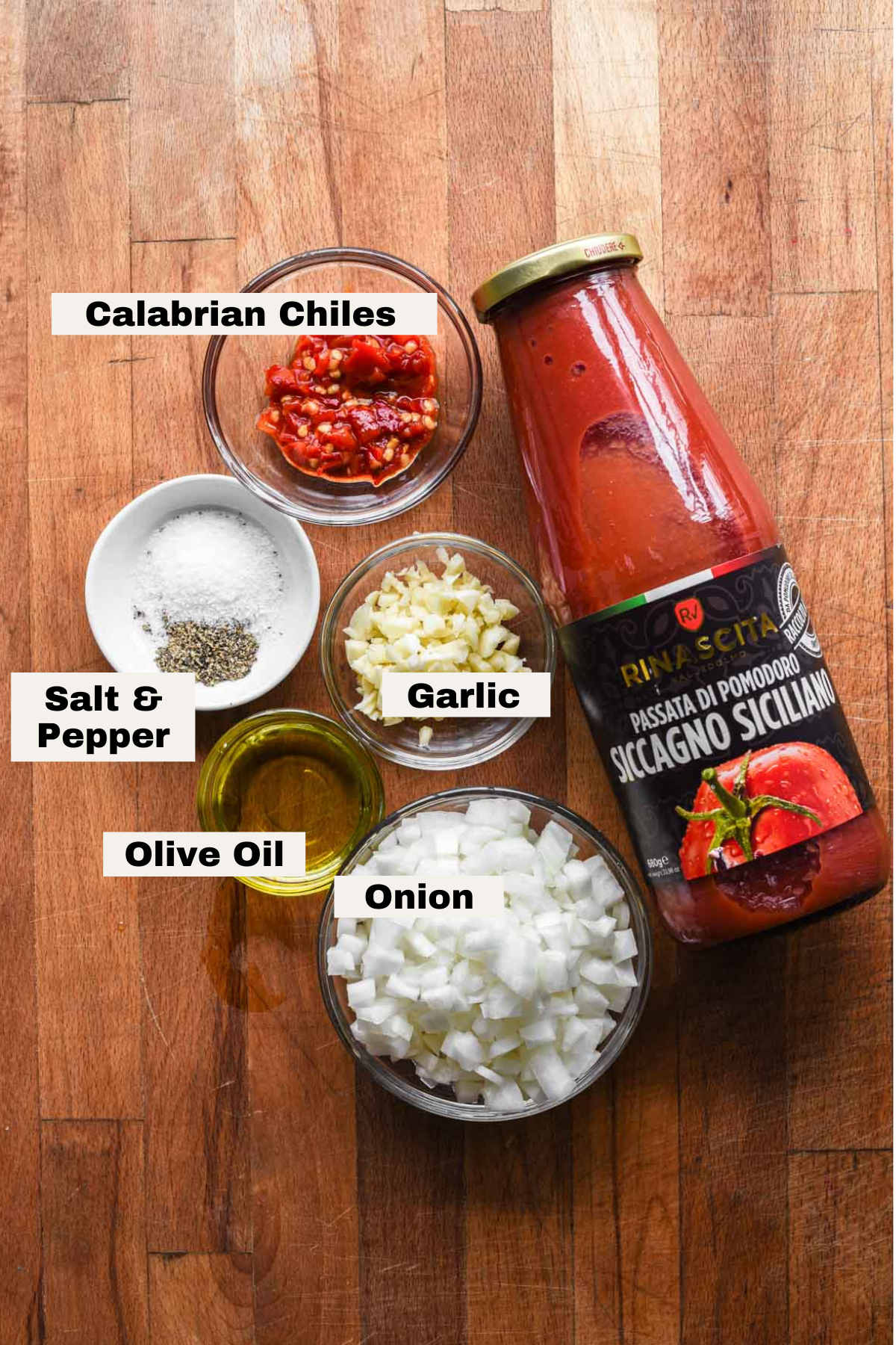 Ingredients needed for spicy tomato sauce on a table.