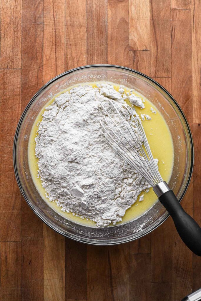 Mixing flour into wet ingredients.
