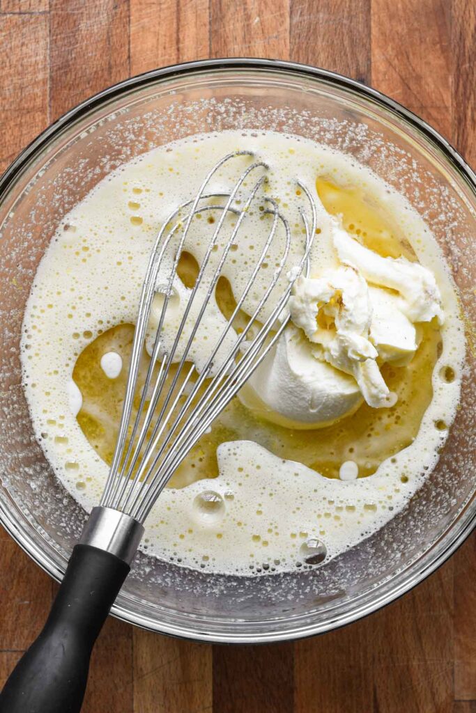 Mixing wet ingredients into lemon sugar.