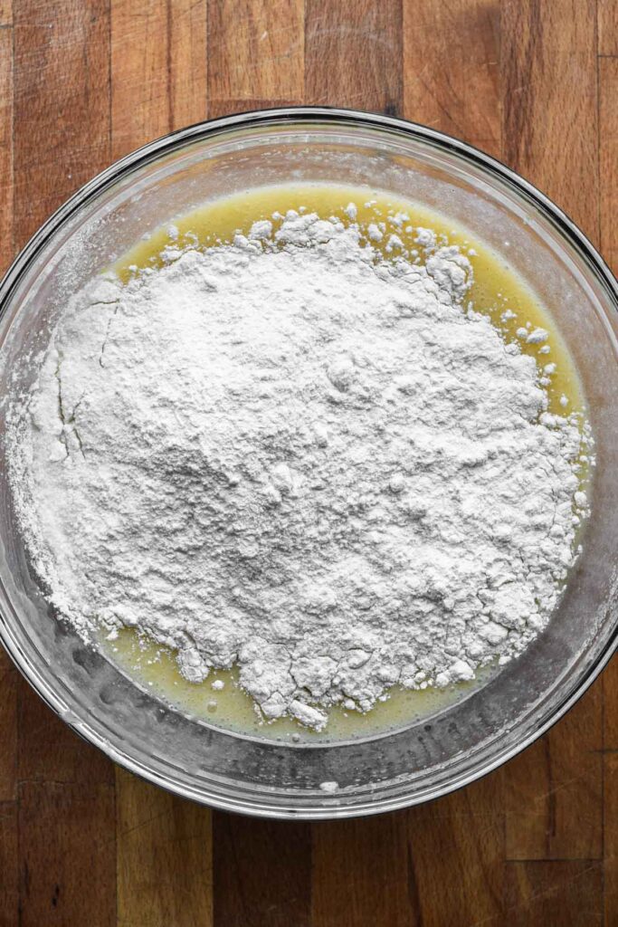 Adding dry ingredients to wet.