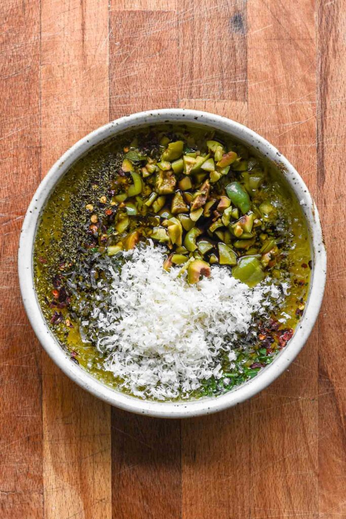 Olive oil bread dip ingredients in a bowl together.