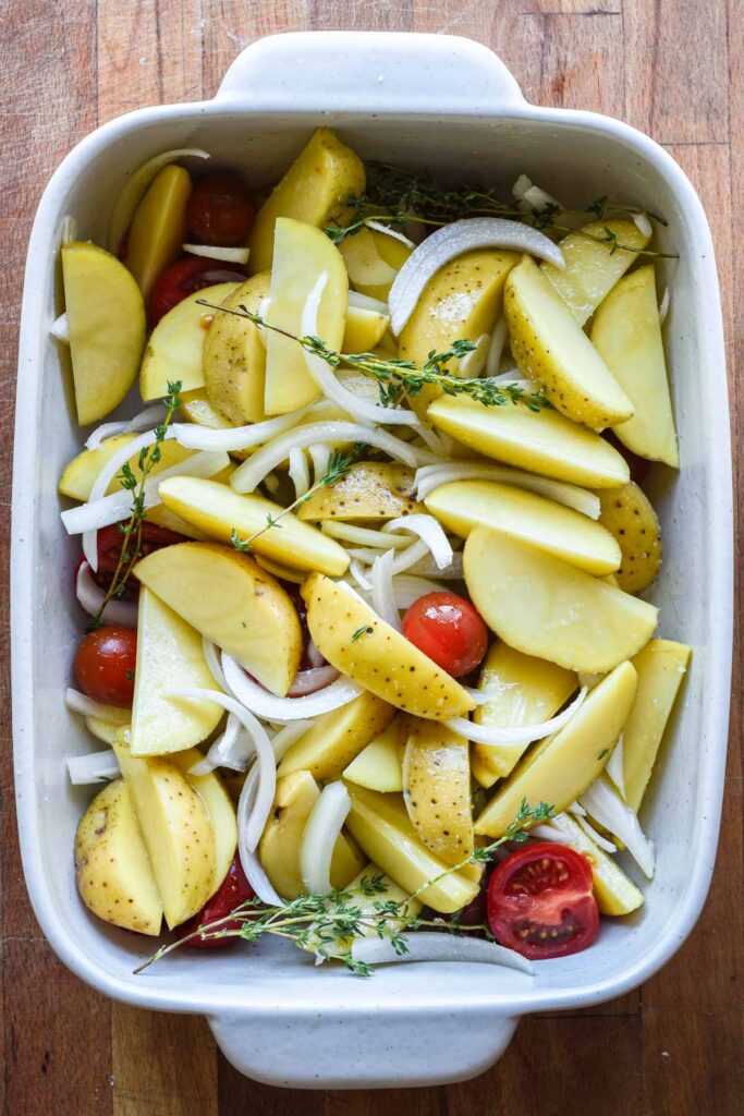 Ingredients tossed together in a baking dish before being baked.