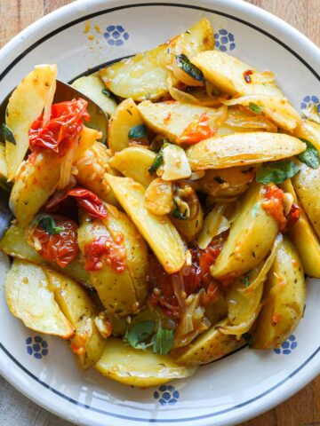 Finished roasted potatoes in a bowl for serving.