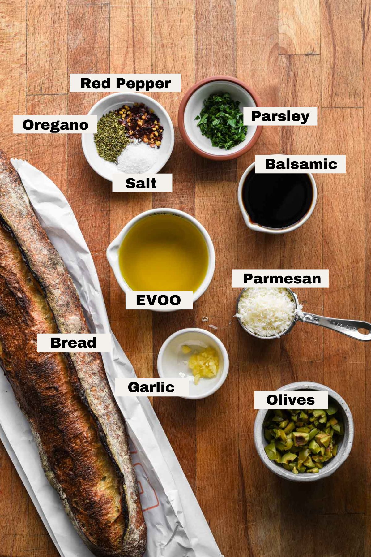 Ingredients for olive oil bread dip on a table.