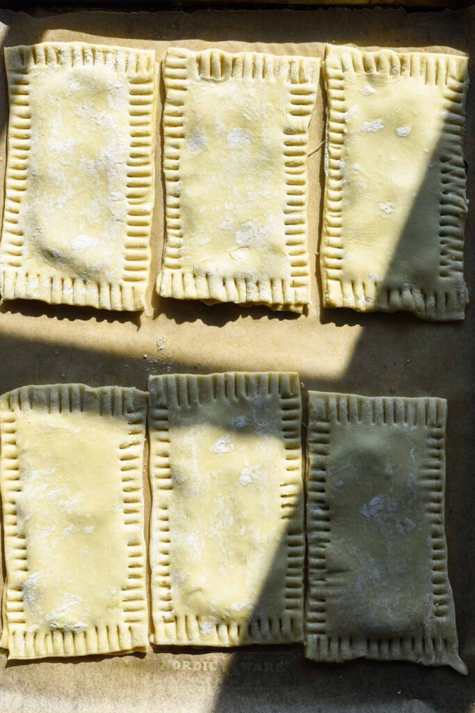 Puff pastry on top layer with edges crimped.