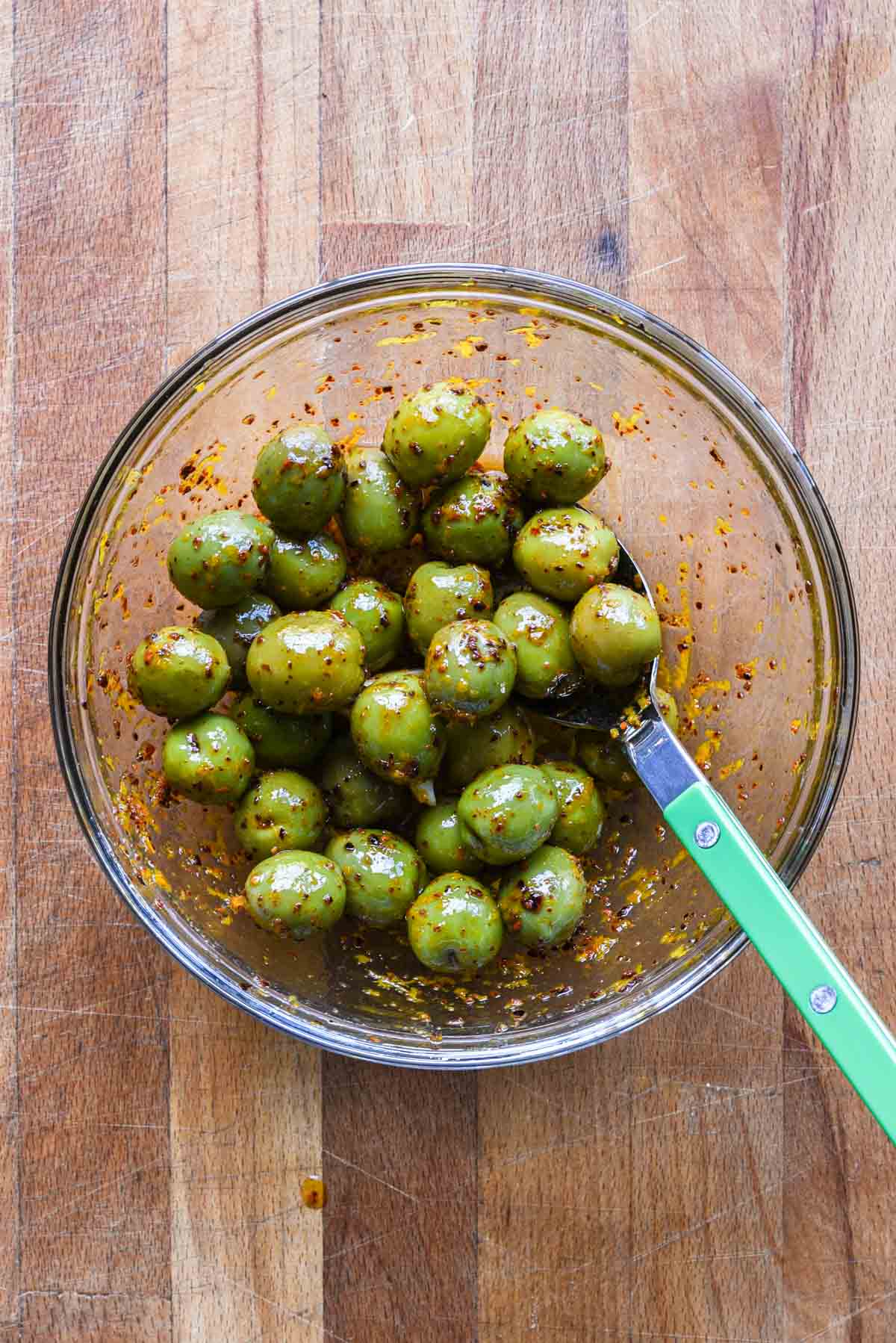Marinated olives in a mixing bowl.