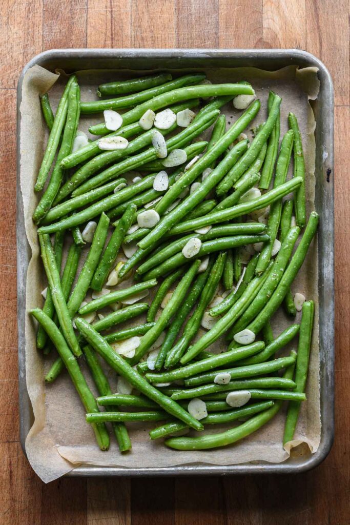 Garlic roasted green beans on a sheet tray.