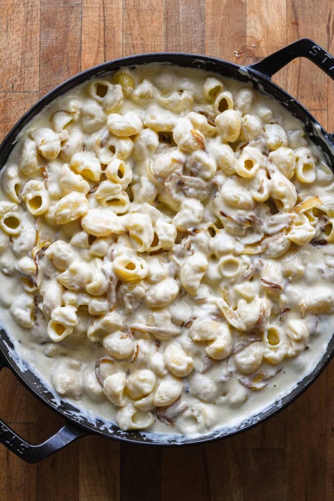 Pasta added to cheese sauce.