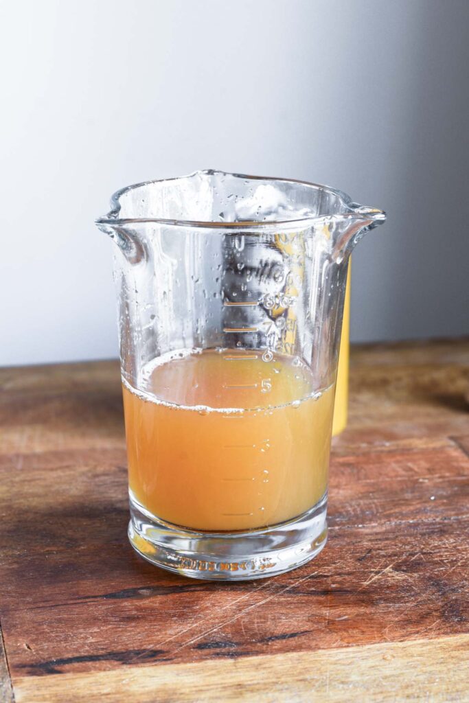 Ingredients added to a measuring cup.