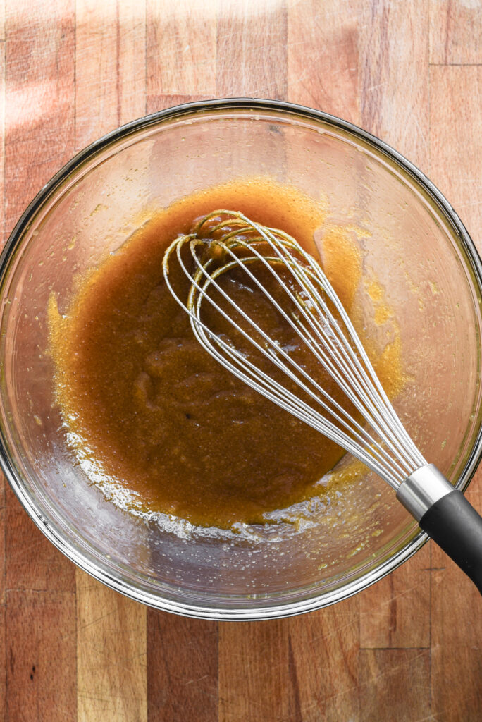 Butter and sugars whisked in a bowl.