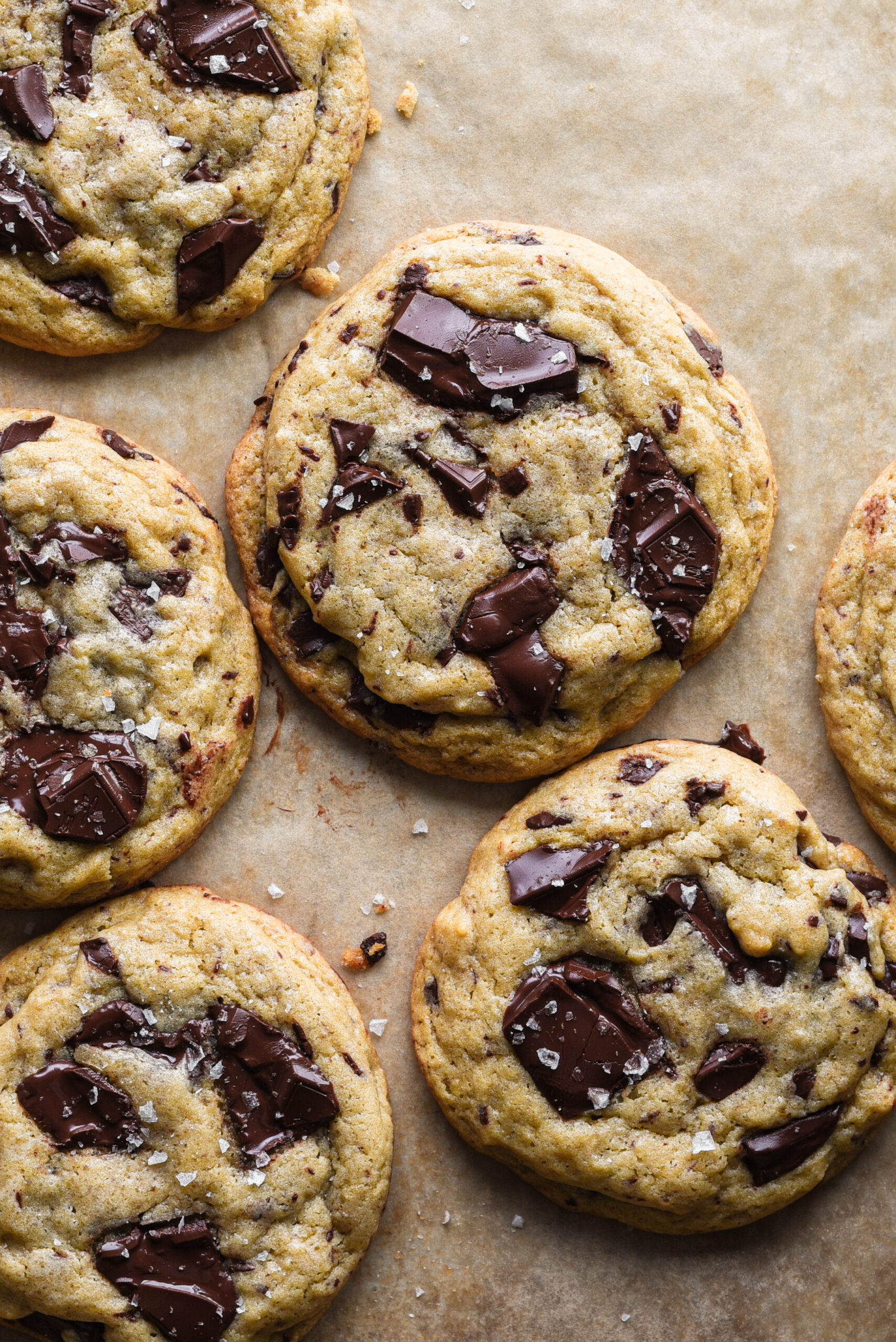 Cookies on baking sheet with puddles of chocolate.