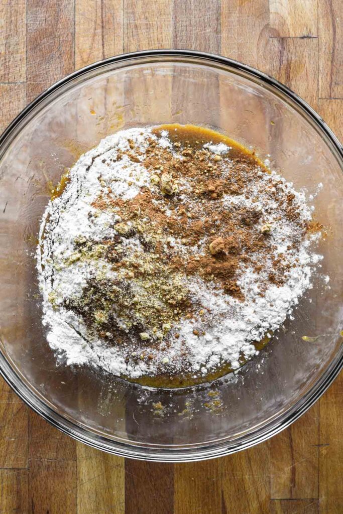 Adding flour, baking soda, spices, and salt.