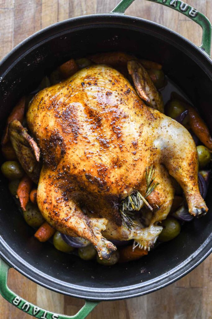 Finished whole roasted chicken in a cast iron.