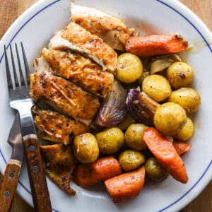 Dutch oven roasted chicken served on a plate.