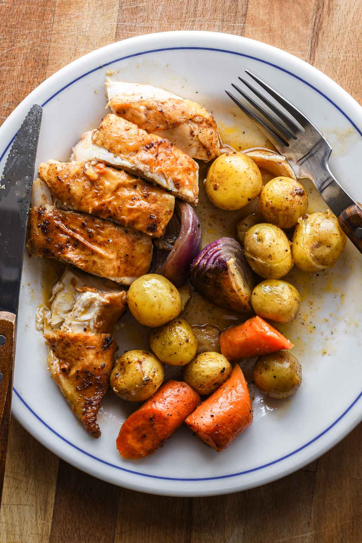 Cutting into the chicken on a plate.