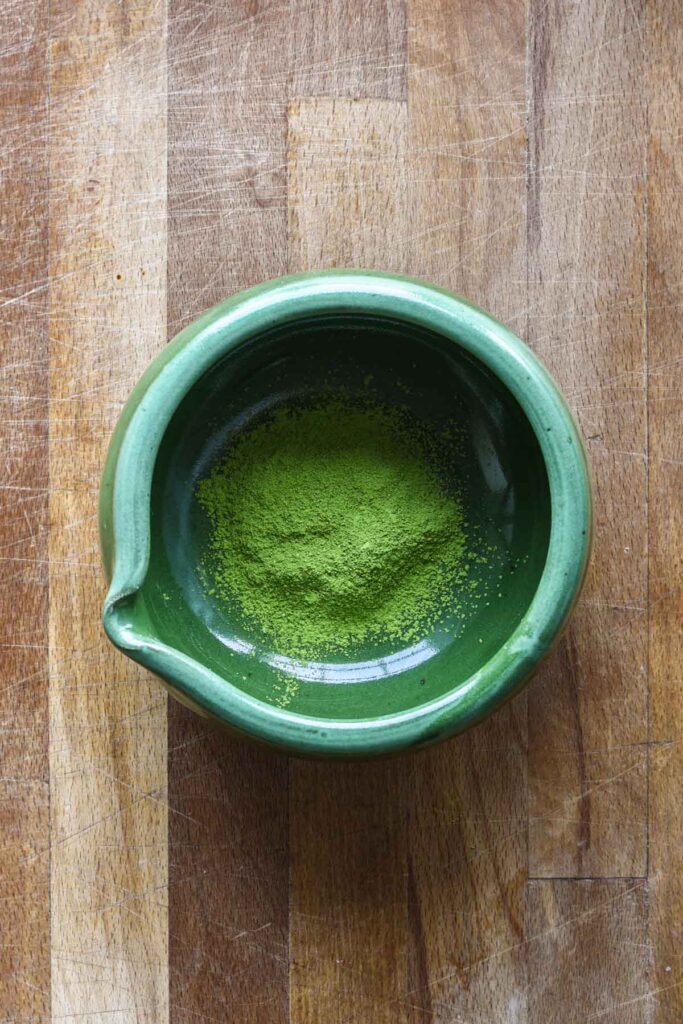 Matcha powder sifted into a bowl.