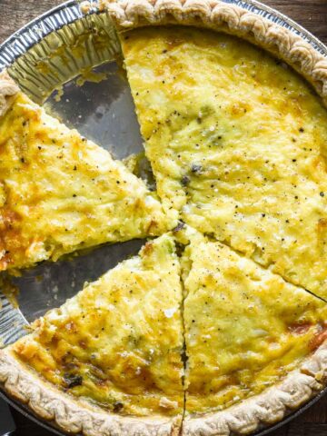 Close up image of sliced leek and gruyere quiche.