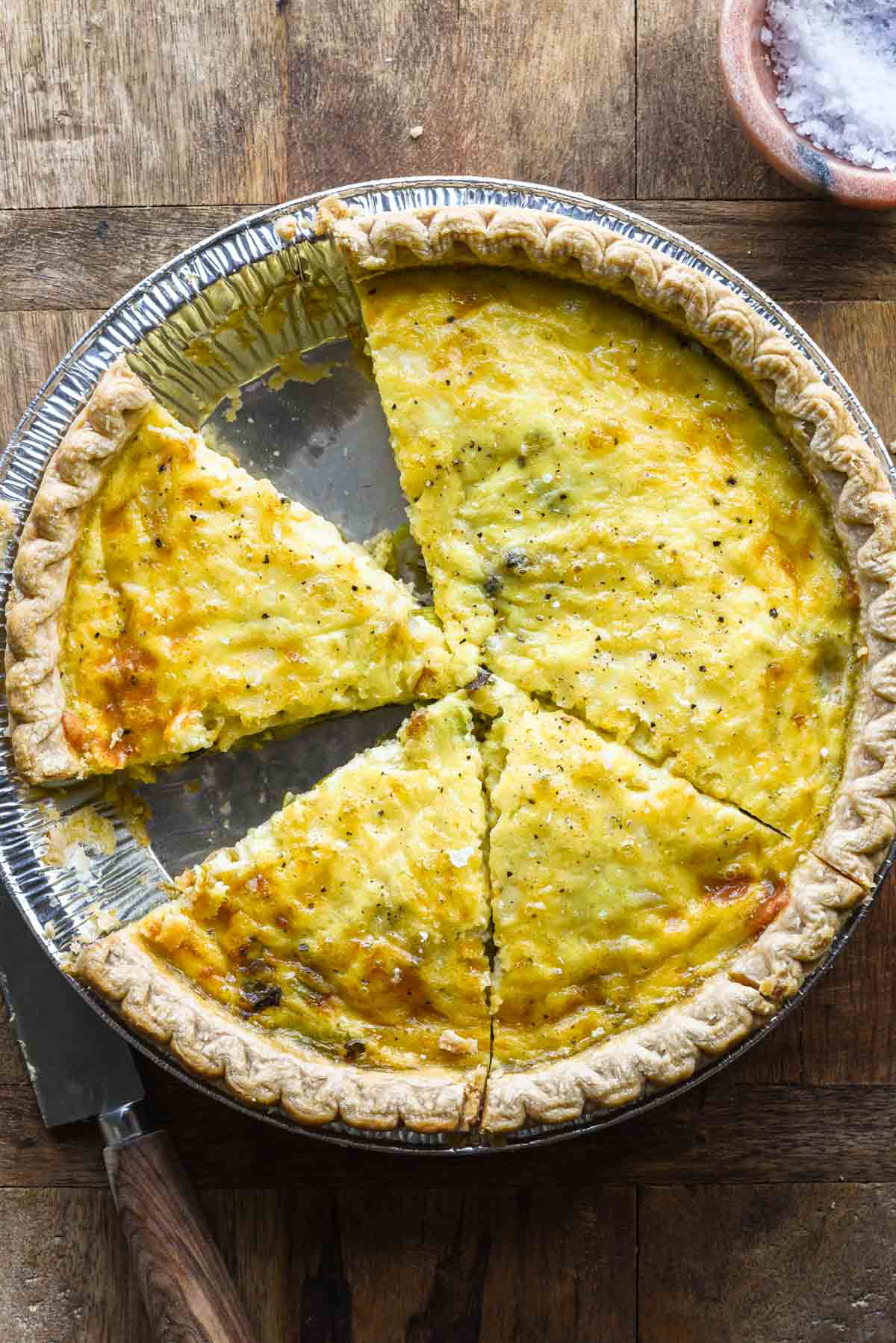 Close up image of sliced leek and gruyere quiche.
