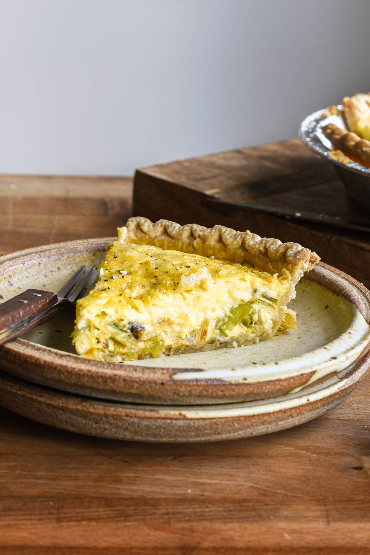 Slice of quiche on a plate.