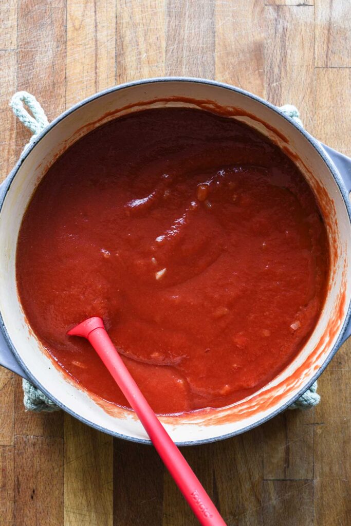 Passata added to sauce.