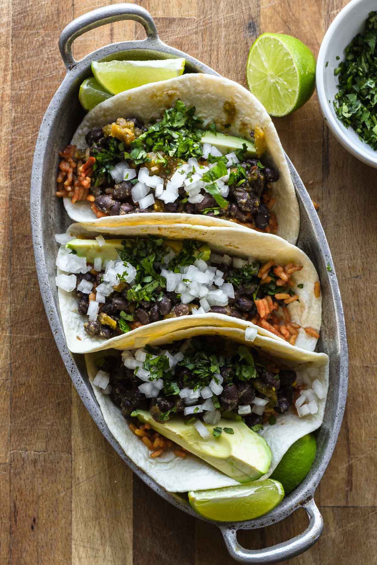 Assembled tacos up close in a serving table.