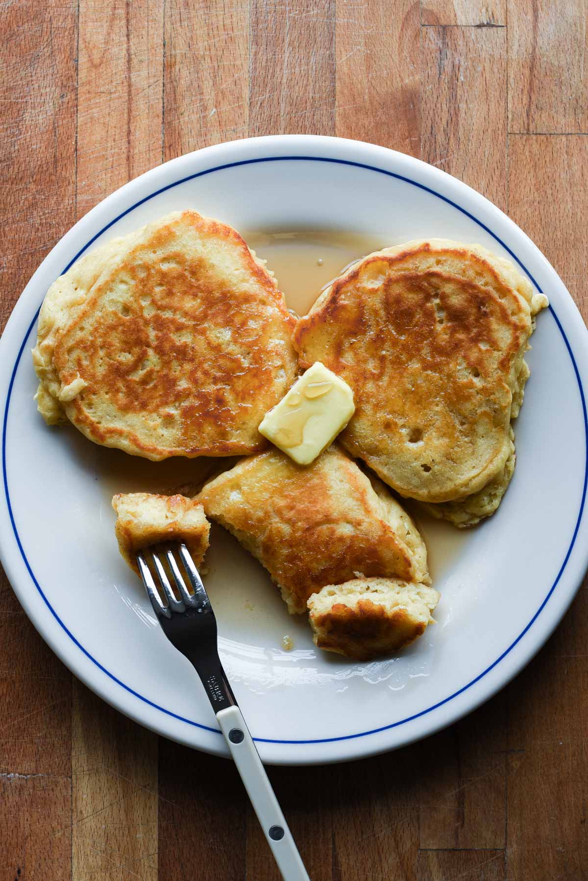 Close up buttermilk pancakes for two with fork.