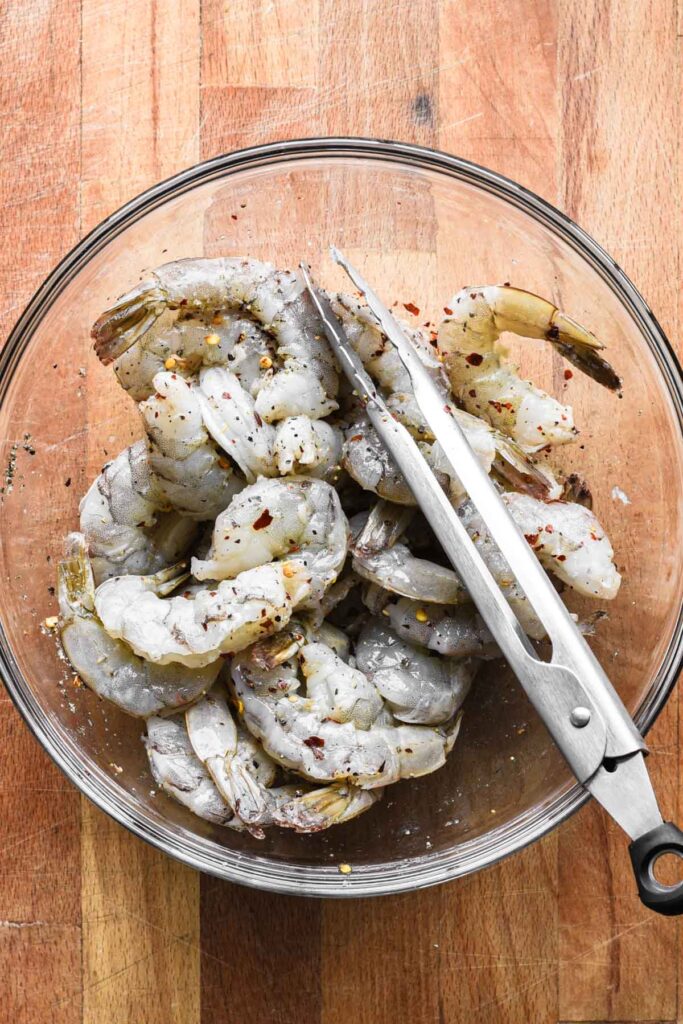 Shrimp combined with salt, pepper, and red pepper flakes.