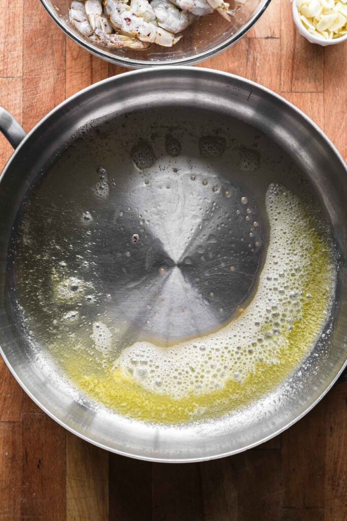 Melting butter in a large skillet.