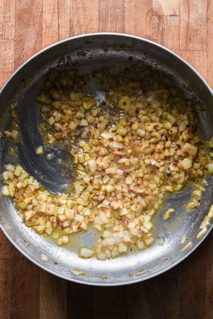 Garlic and onion added to the skillet with olive oil.