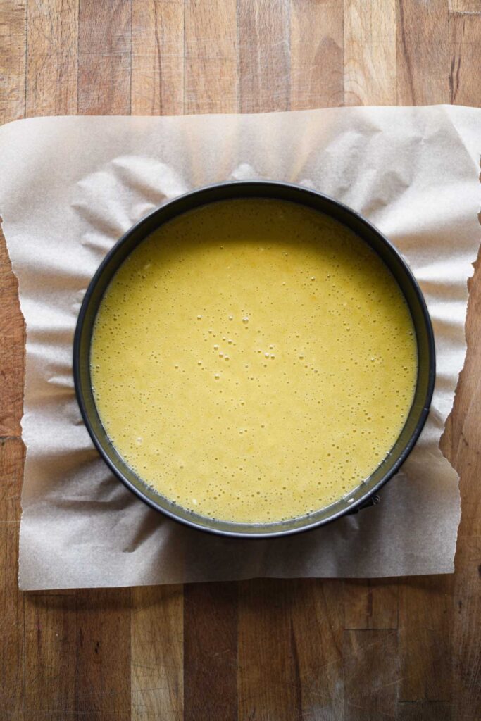 Batter poured into a round baking pan.