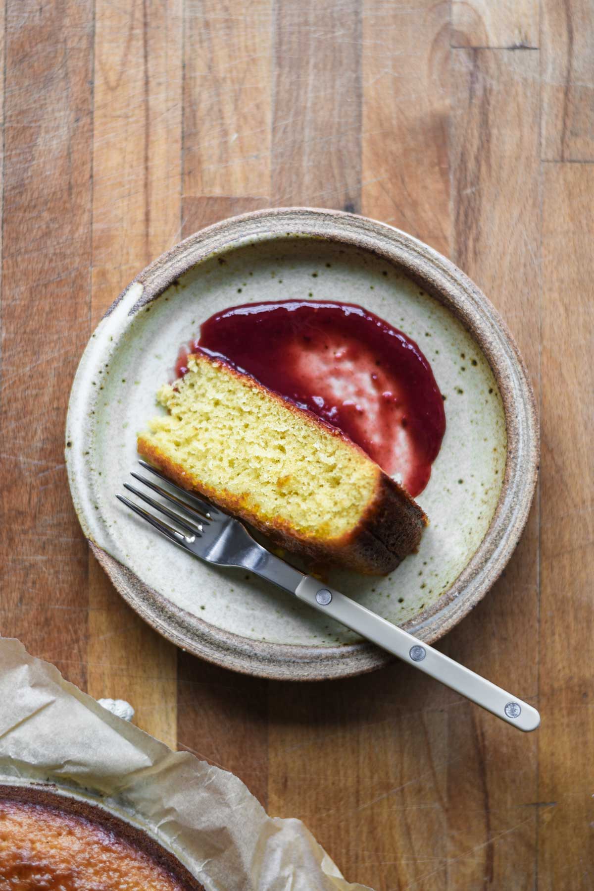 Cake slice on a plate with jam.