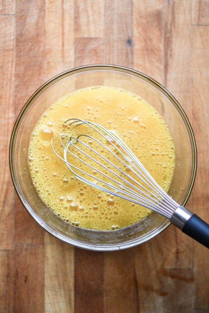 Whisked eggs in a bowl.