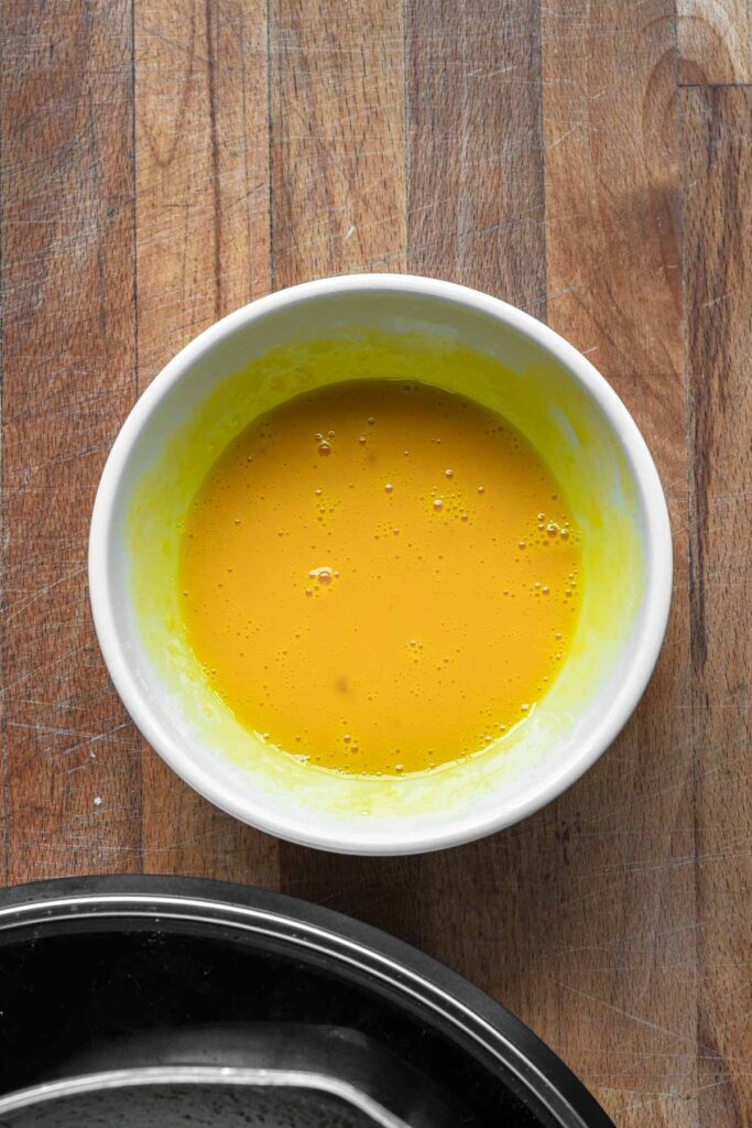 Tempering egg yolks.